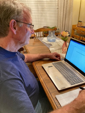 John Odland at a computer working on plans for a coaching session